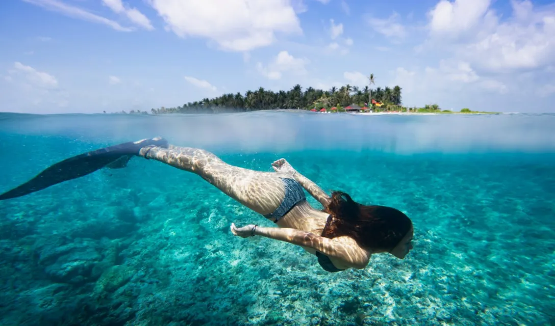 Couple snorkeling in crystal clear lagoon